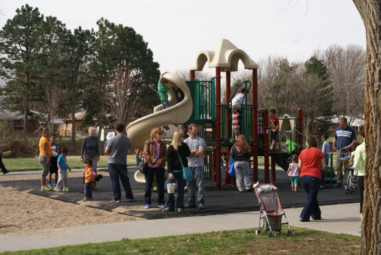 Parents and children at McAdams Park play structure