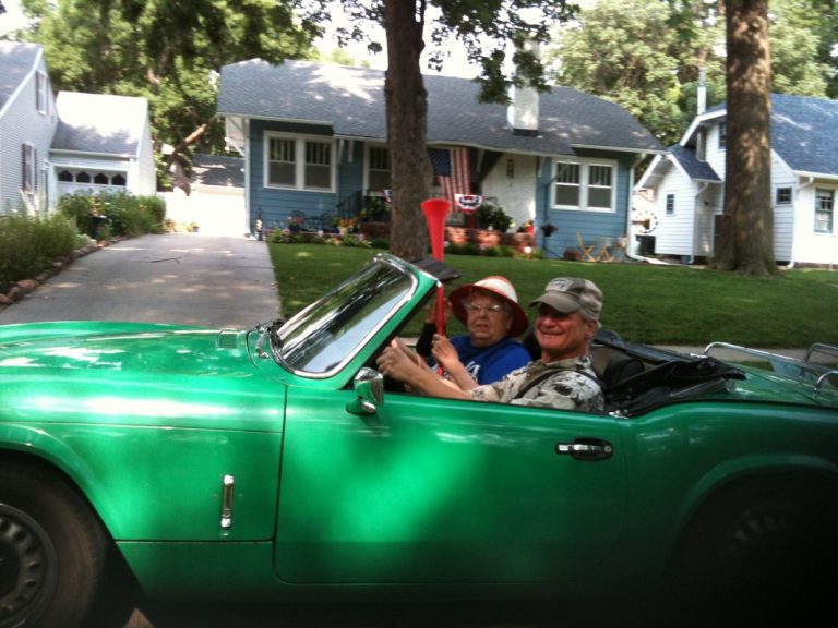 People in vintage green convertible sports car, ECCO 4th of July Parade 2015