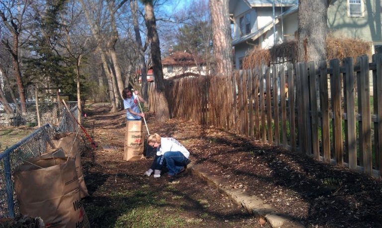 Community members clean and mulch footpath to University of Nebraska Administration Building's specimen garden